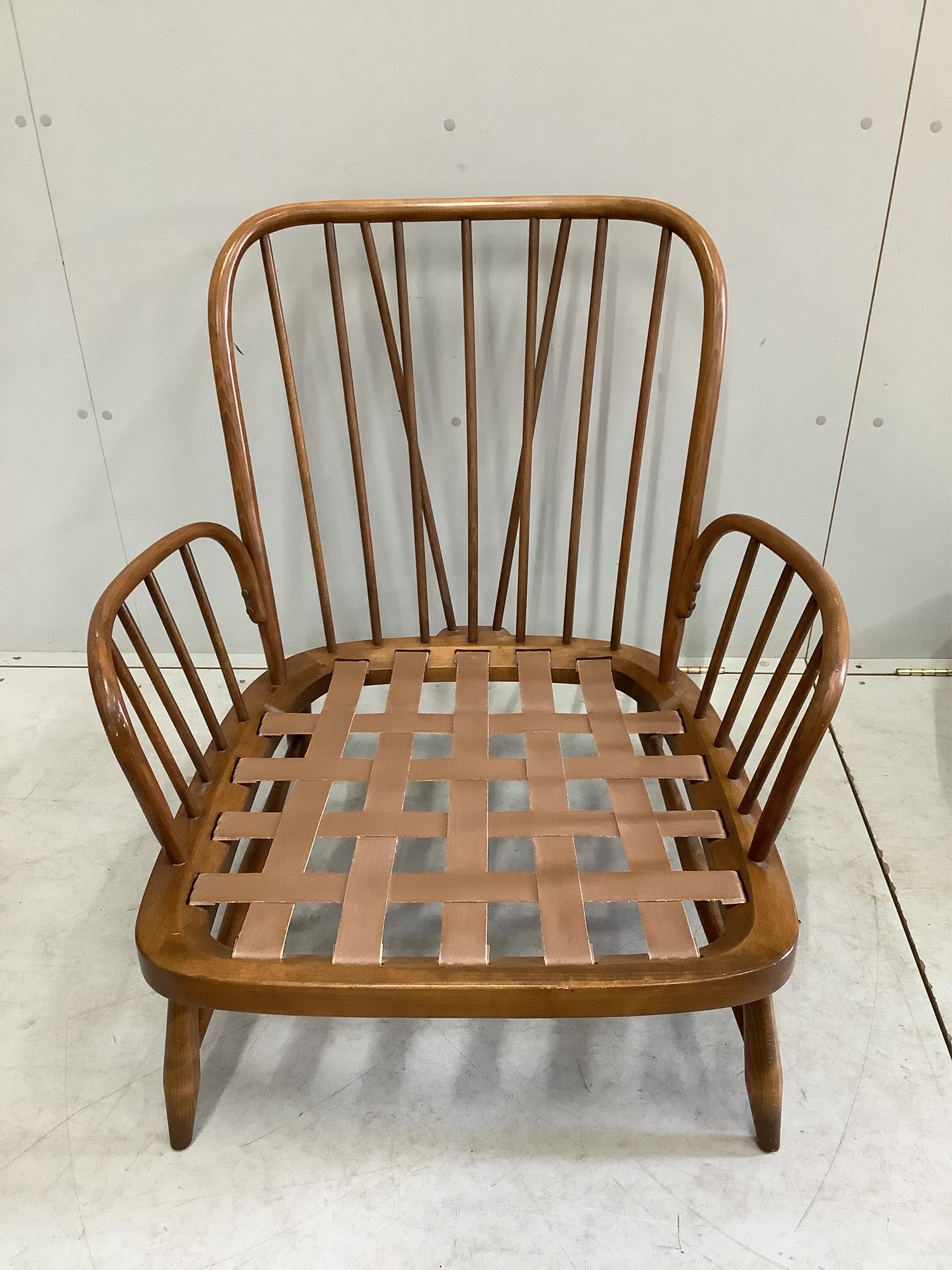An Ercol beech armchair and a foot stool, together with one other Ercol beech armchair, larger 75cm, depth 78cm, height 90cm. Condition - good